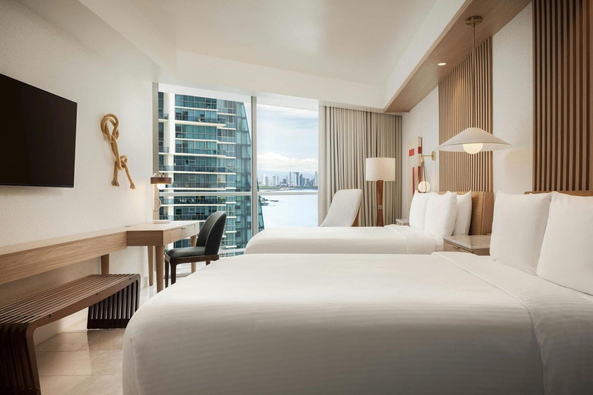 Guest room 2 double beds balcony partial ocean view