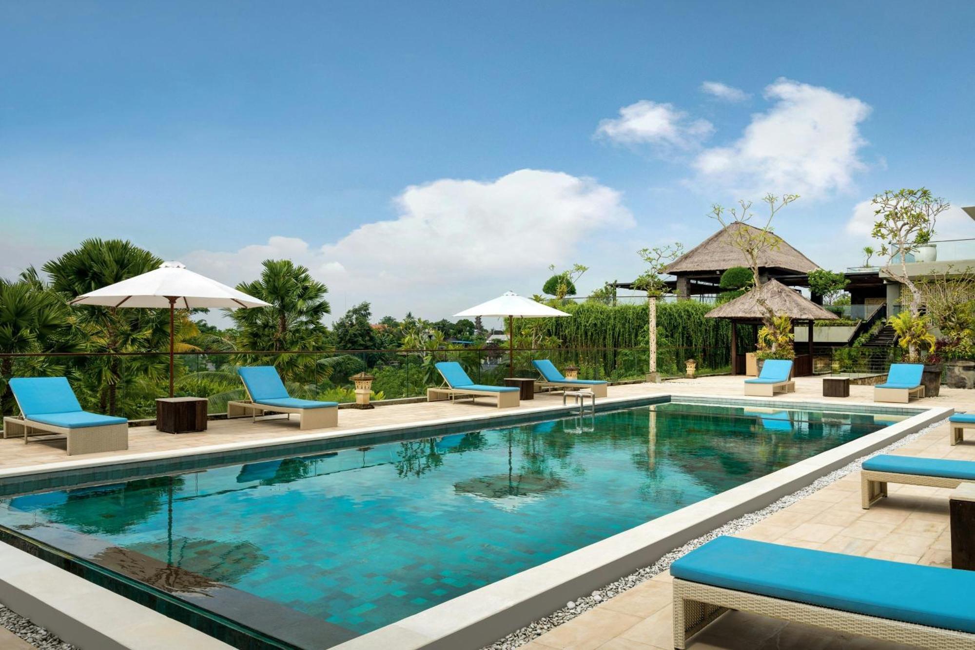 Deluxe King Balcony Room with Pool View, with FREE daily shuttle to Ubud City, FREE Photo Session, FREE Art Gallery Visit, 24-hour access to Fitness Center, FREE Welcome Drink, and FREE Kids Activities.